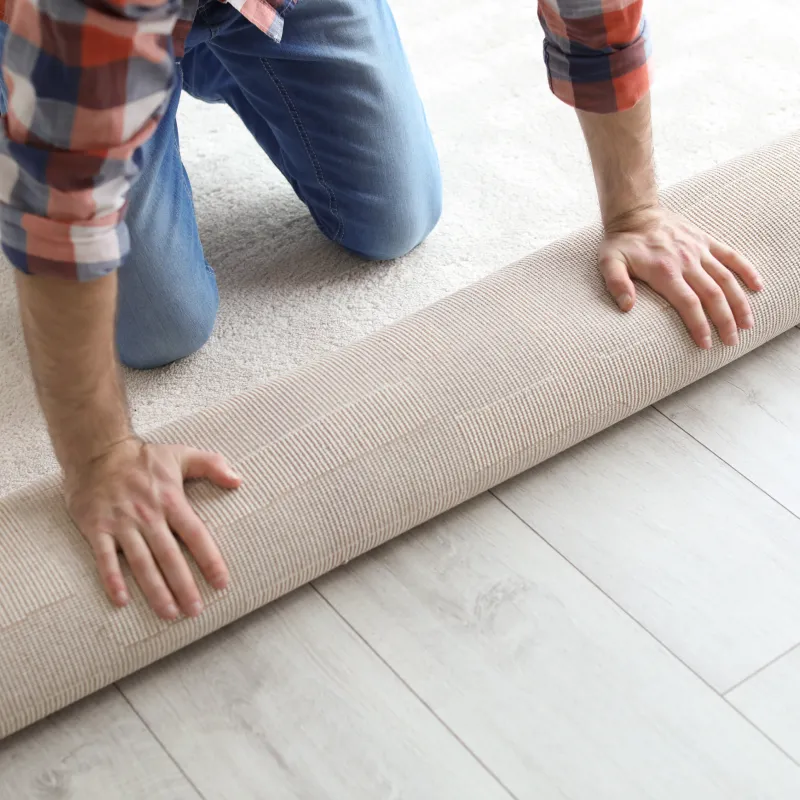 Worker installing carpet | Pilot Floor Covering