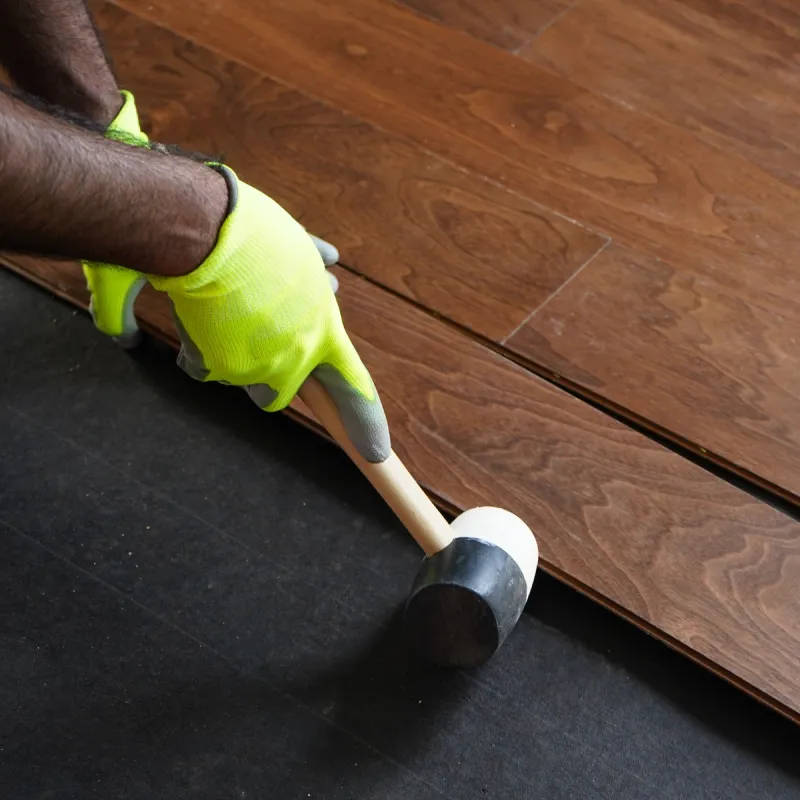 Worker installing hardwood flooring | Pilot Floor Covering