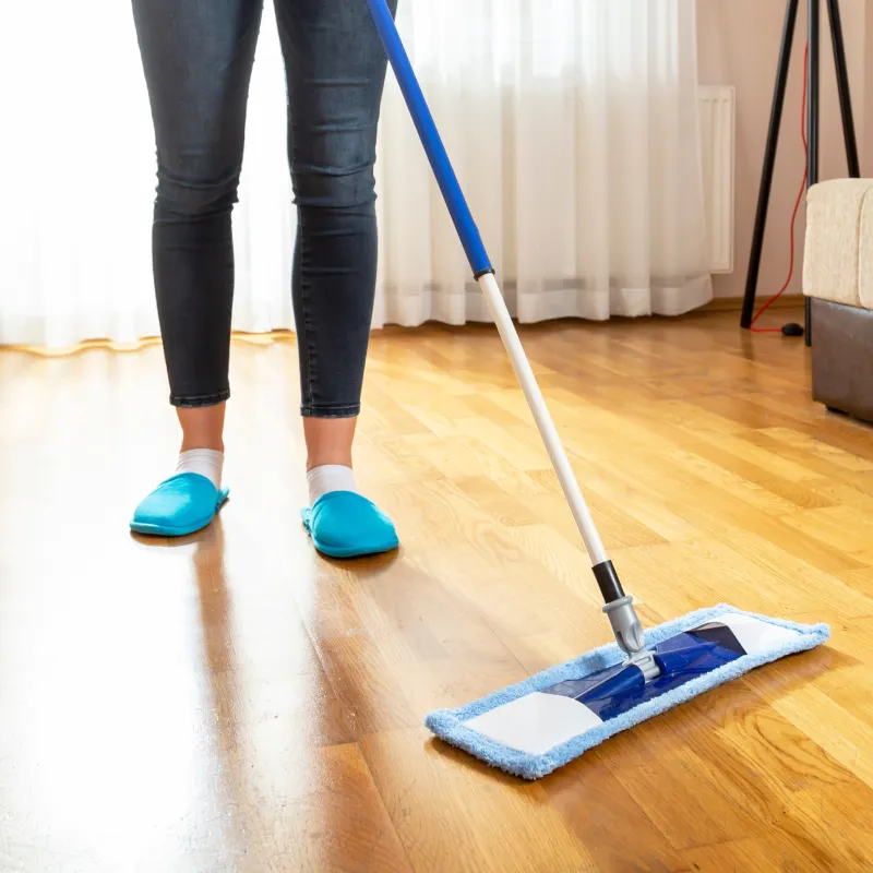 Woman sweeping laminate floor with microfiber | Pilot Floor Covering